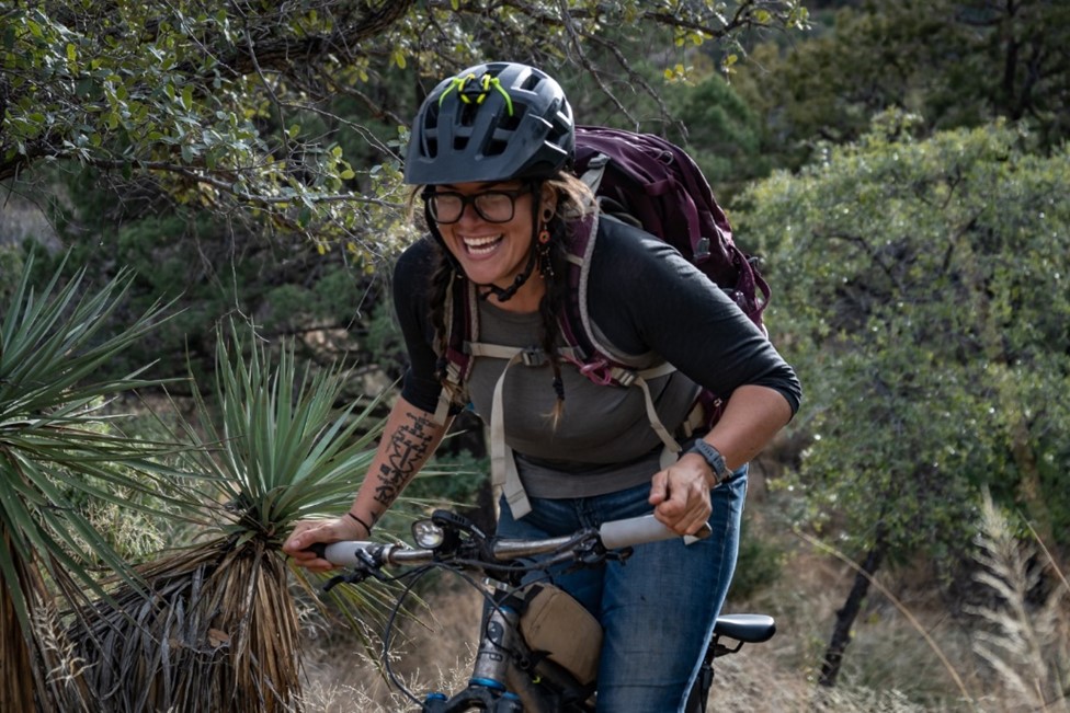 Photo of Alexandera Houchin biking in a park
