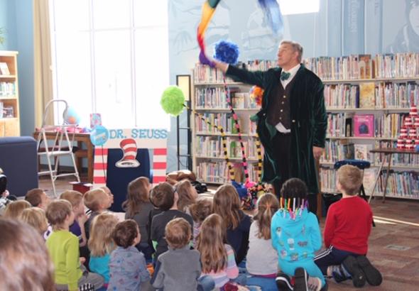 Magician performing for kids at a library